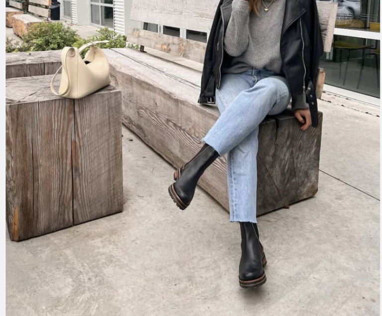 woman wearing Chelsea boots, sitting crossed legged